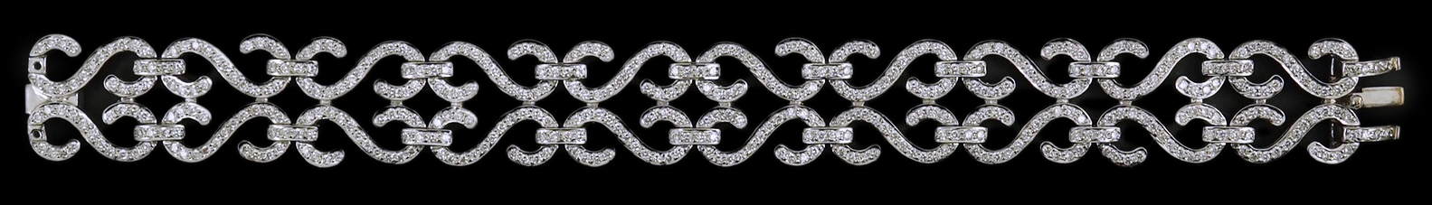 A modern 18k white gold and diamond chip cluster set bracelet